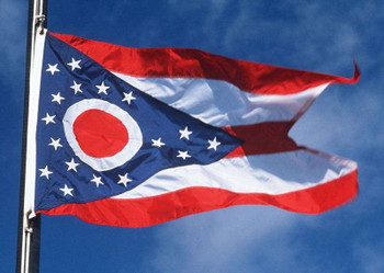 Ohio state flag waving against a clear blue sky.