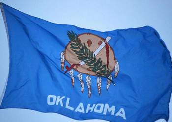 The Oklahoma state flag with its distinctive emblem and blue background.